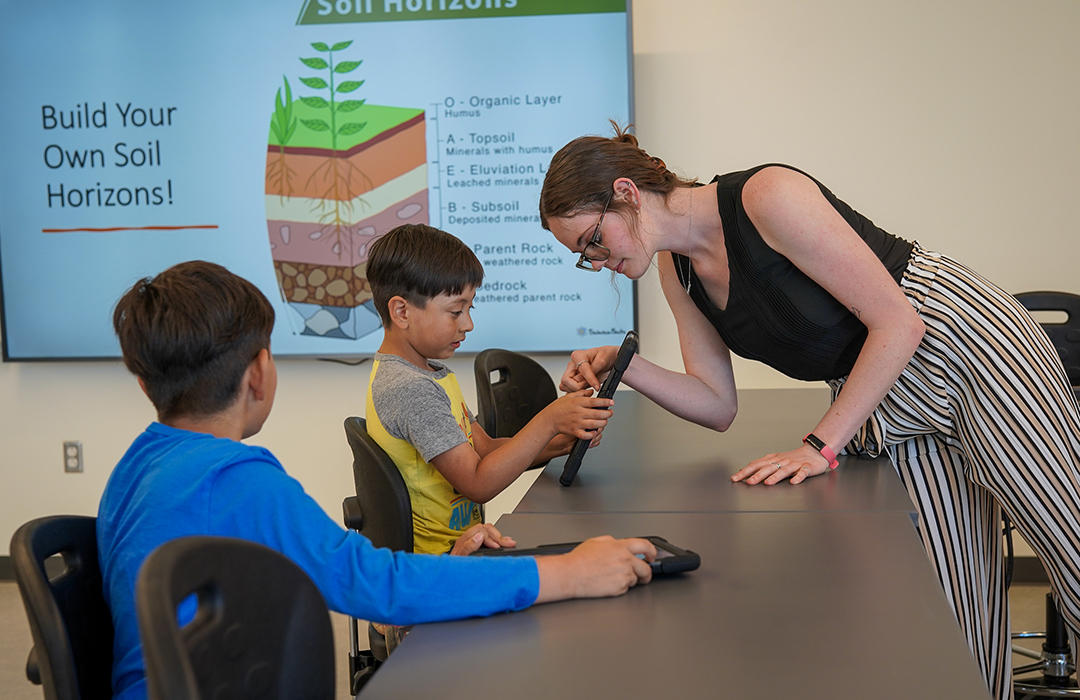 teacher and student looking at tablet