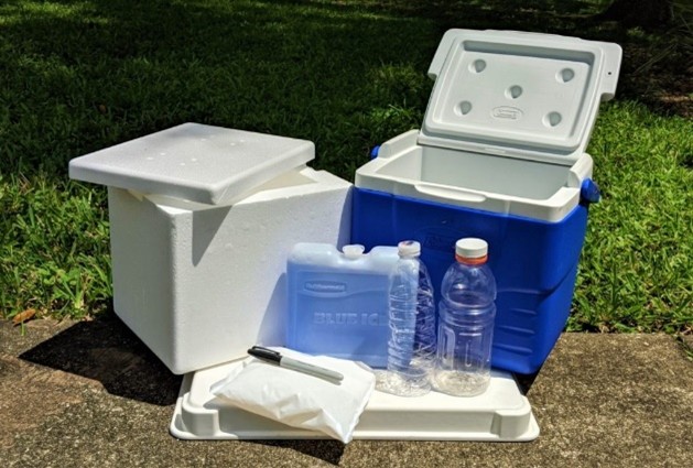 Water coolers, stryofoam and hard plastic, with an ice pack, empty water bottles, a sharpie, and a plastic bag. 
