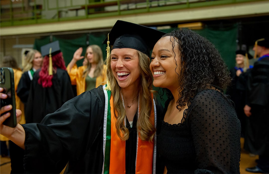 Students pose for a photo at graduation.