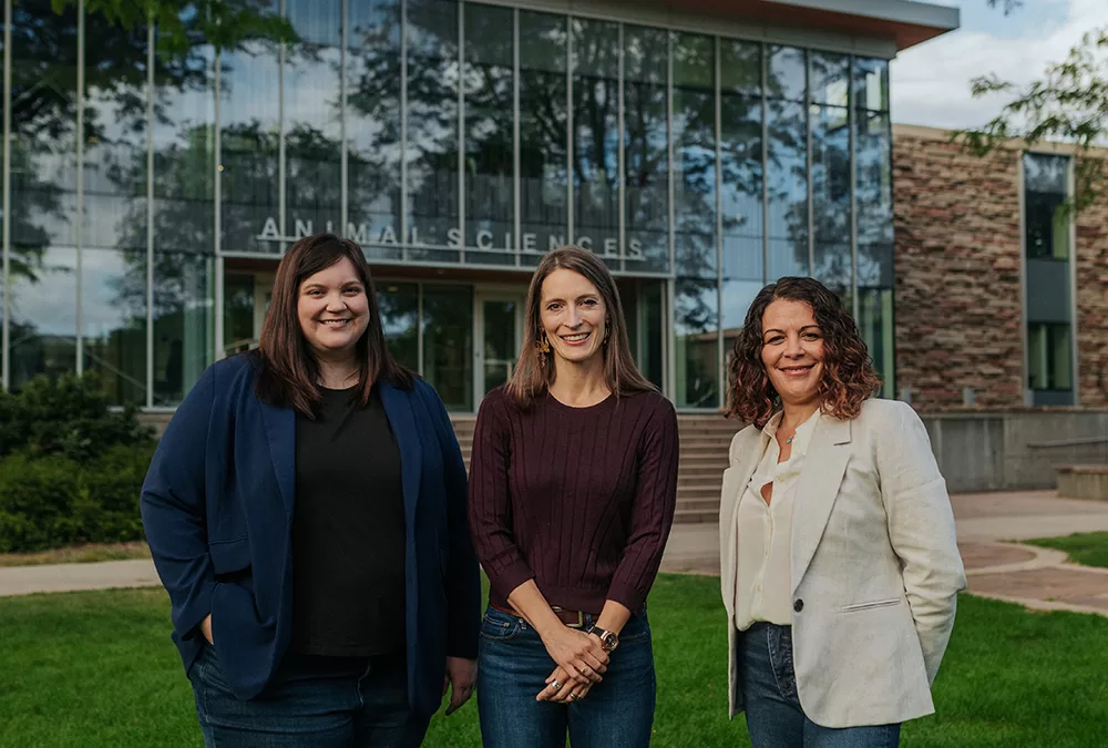 Three women standing outside the Animal Sciences building