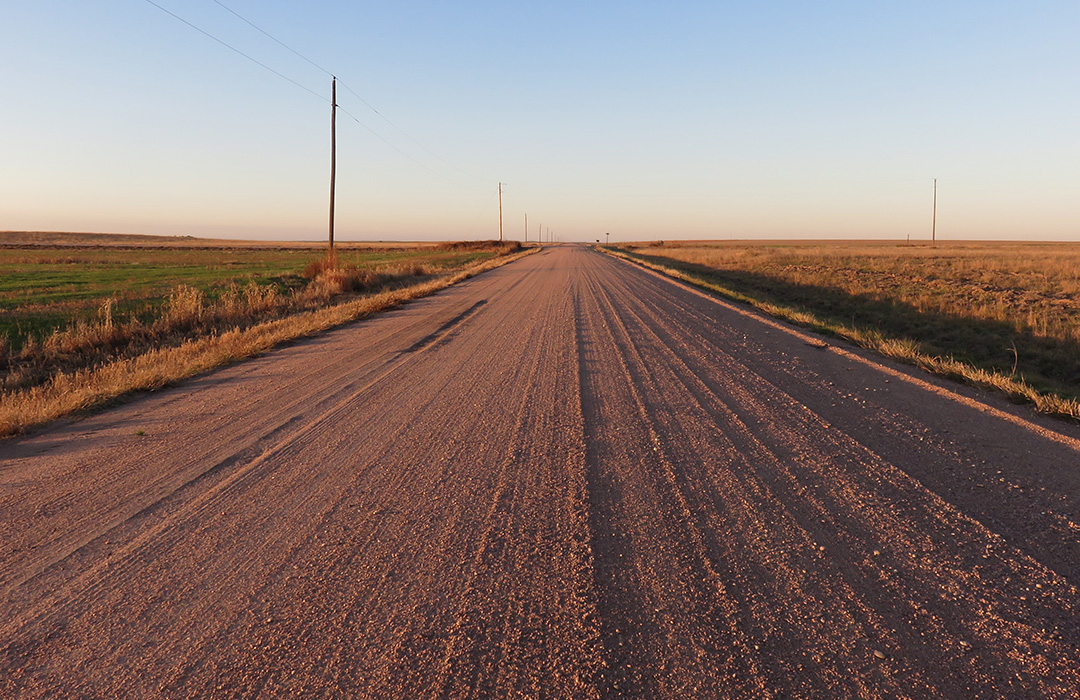 A long gravel road at sunset in Yuma, CO
