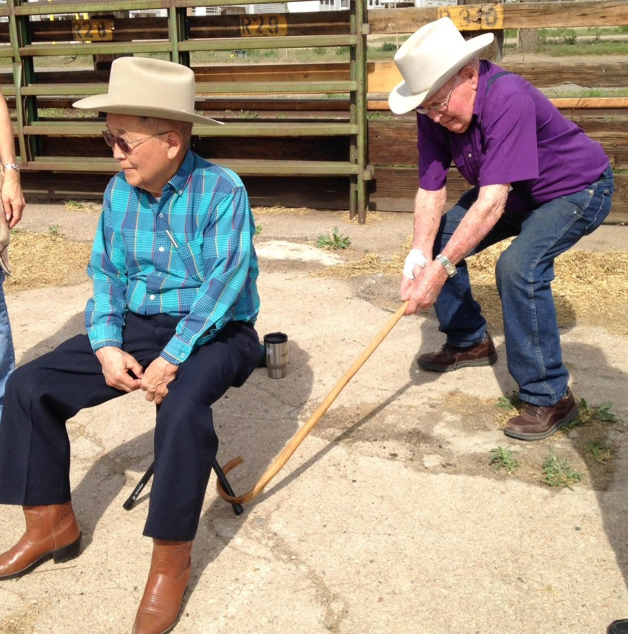 Chuck Waneka pulling a prank on Dr. Matsushima while they were part of giving out calves for Catch-a-Calf at the NWSS.